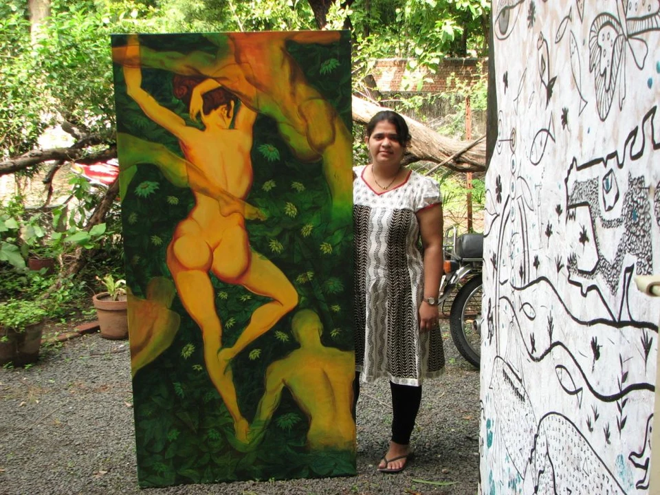 Deepti J. Shah beside a painting made under Tanul Vikamshi’s guidance
